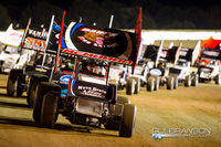 In front of and pacing the full of World of Outlaws Sprint Car field